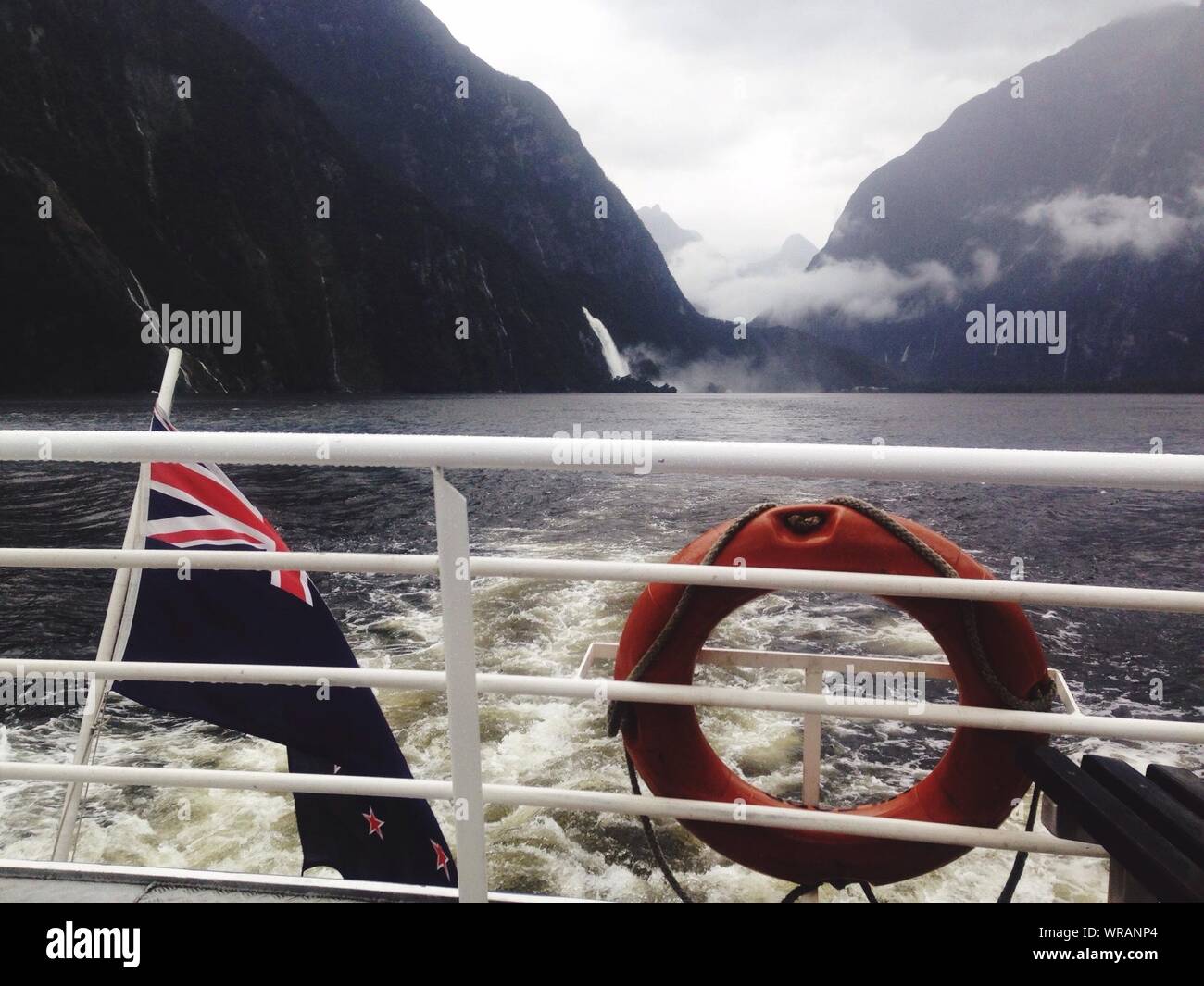 Life Belt And New Zealand Flag By Railing On Boat Stock Photo
