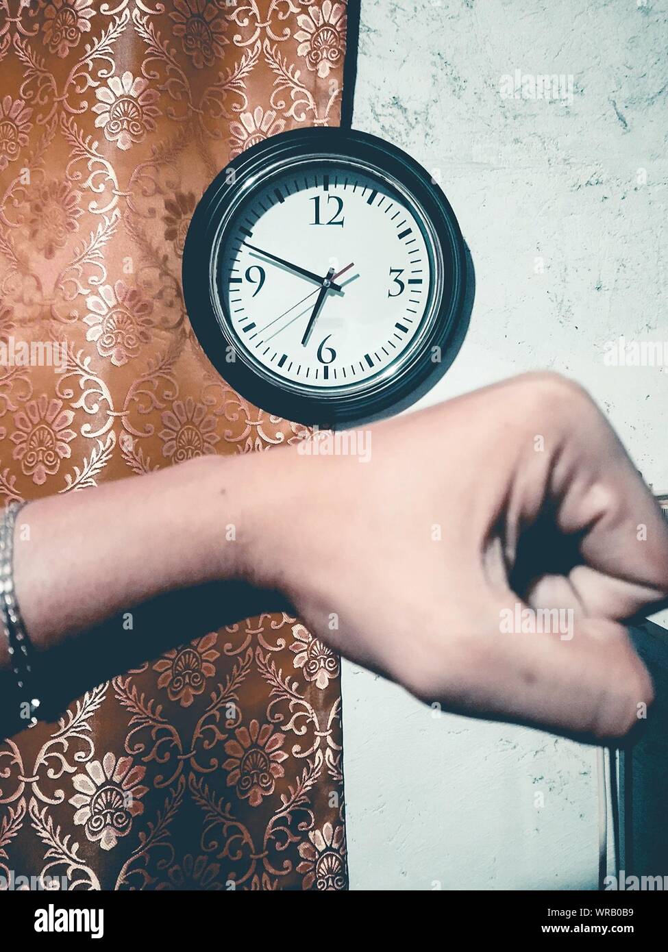 Optical Illusion Of Hand Wearing Clock At Home Stock Photo Alamy