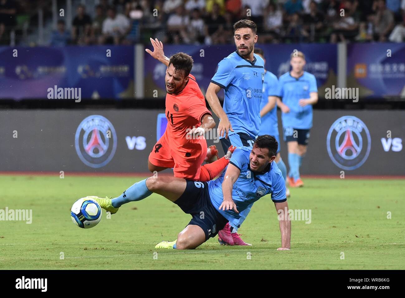 Juan Bernat, left, of Paris Saint-Germain is fouled by Ryan McGowan of Sydney FC during their match of the International Super Cup 2019 in Suzhou City Stock Photo