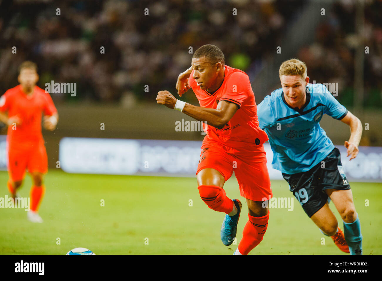 Kylian Mbappe, front, of Paris Saint-Germain challenges Harry Van der Saag  of Sydney FC during their match of the International Super Cup 2019 in Suzh  Stock Photo - Alamy