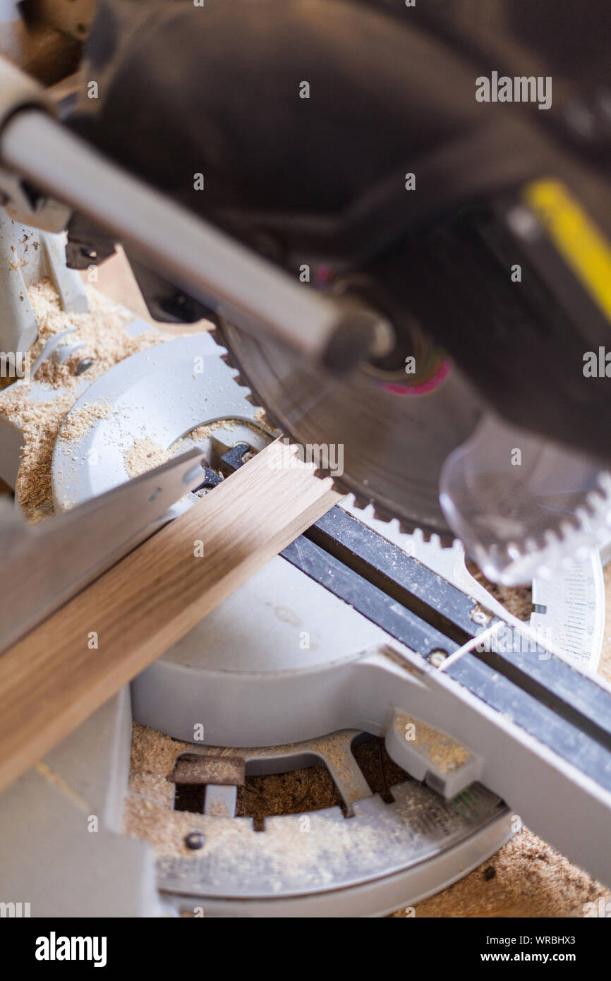 Chop saw Cut wood with saw with saw blade Cut piece of wood into