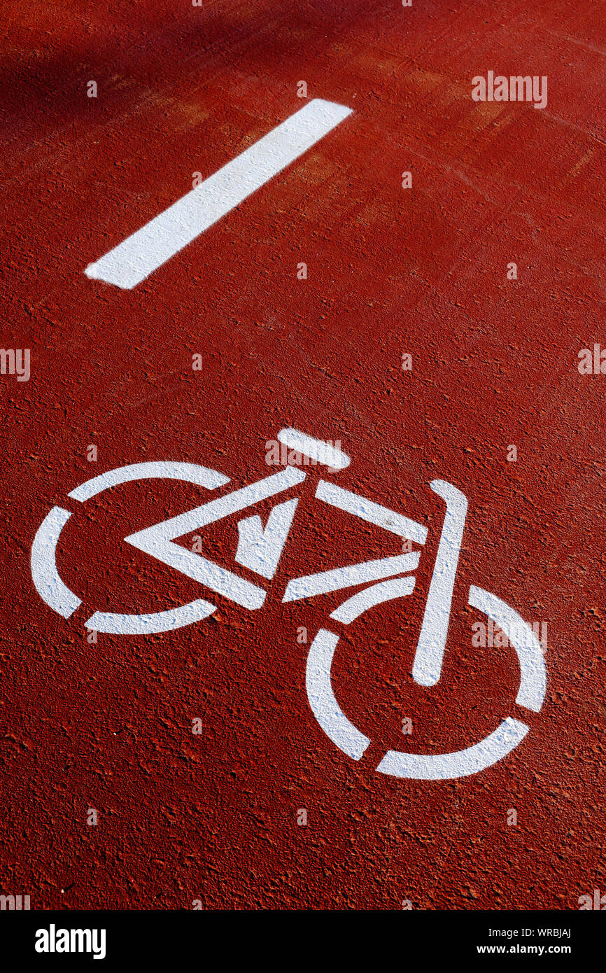 closeup of a bike lane sign, depicted by the silhouette of a white