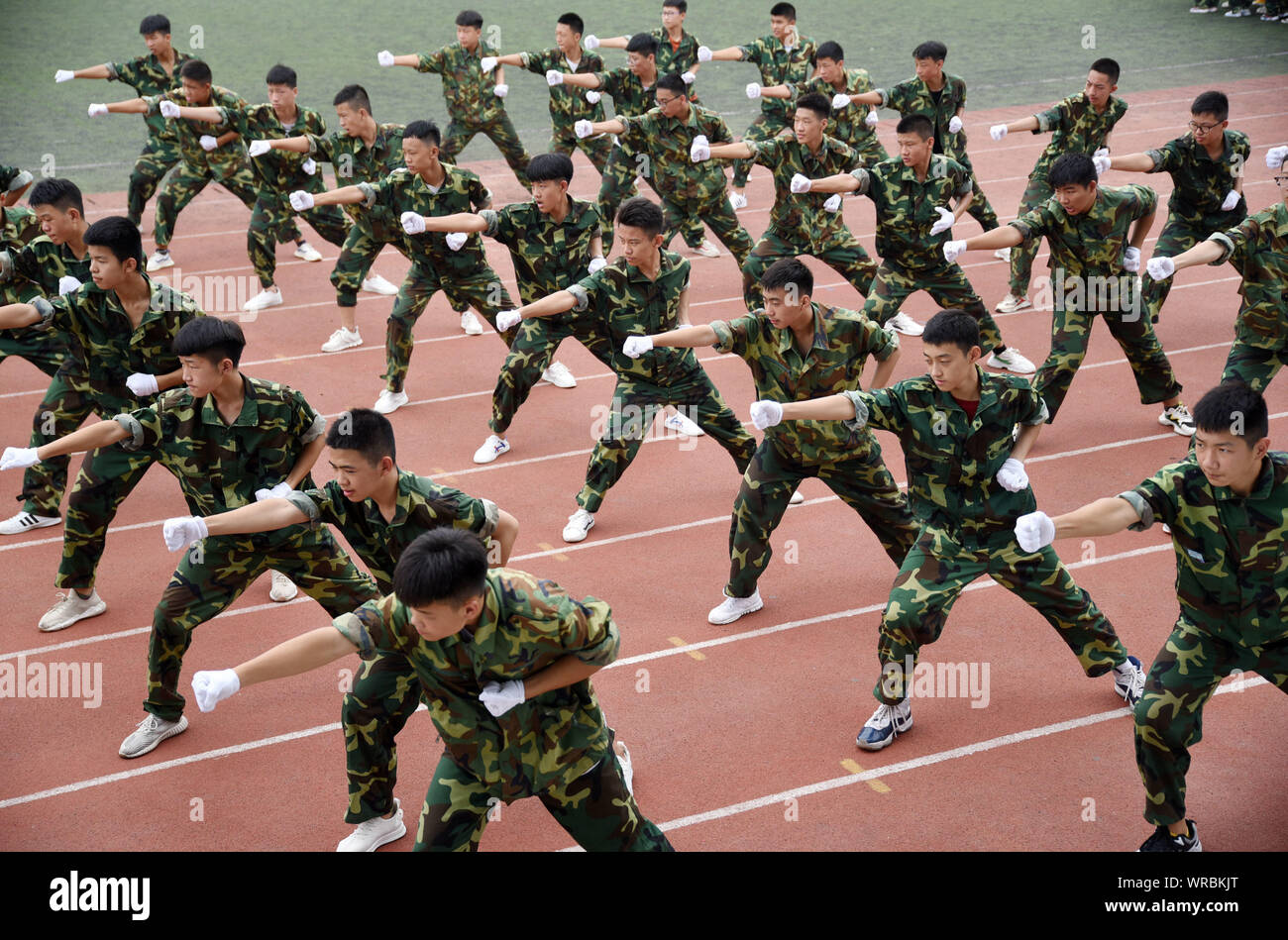 Chinese freshmen students exercise during a military training session