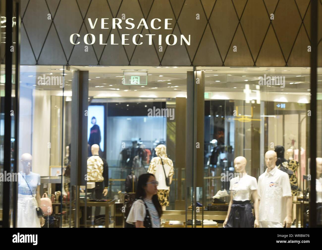 A Chinese woman walks past a fashion boutique of Versace Collection in  Hangzhou City, east China's Zhejiang Province on August 12, 2019. Luxury  bran Stock Photo - Alamy