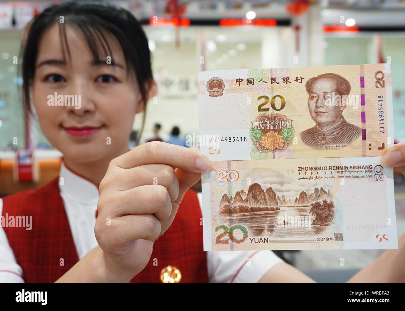 A Chinese Employee Shows Yuan Banknotes Of The 19 Edition Of The Fifth Series Of The Renminbi Rmb At A Bank In Hangzhou City East China S Zhej Stock Photo Alamy