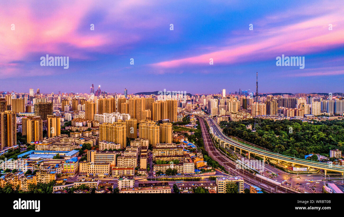 A cityscape at sunset of Xingning District with clusters of skyscrapers, high-rise buildings in Nanning City, south China's Guangxi Zhuang Autonomous Stock Photo