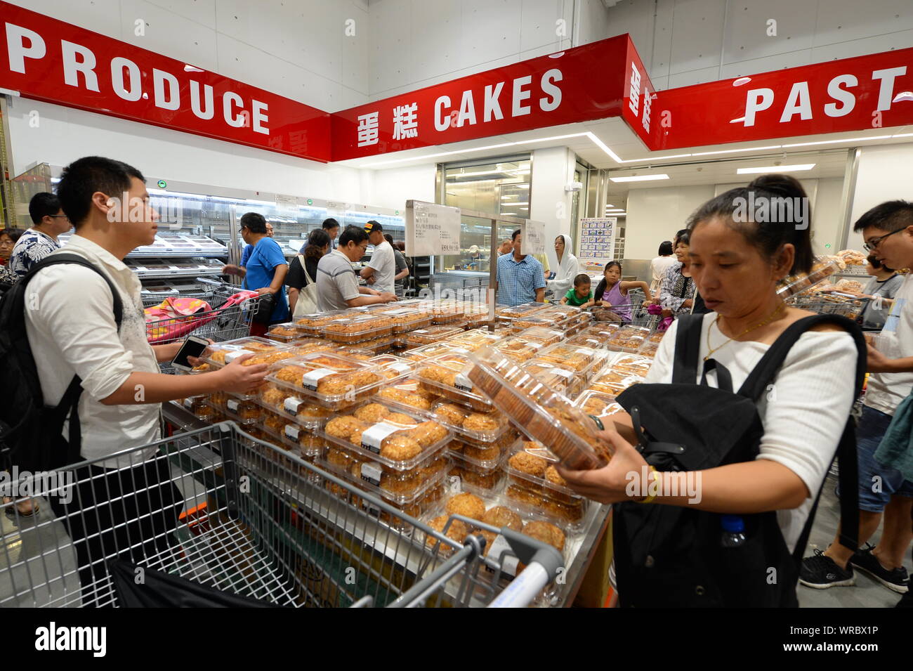 Chinese shoppers buy cakes at the Costco store in Shanghai, China on
