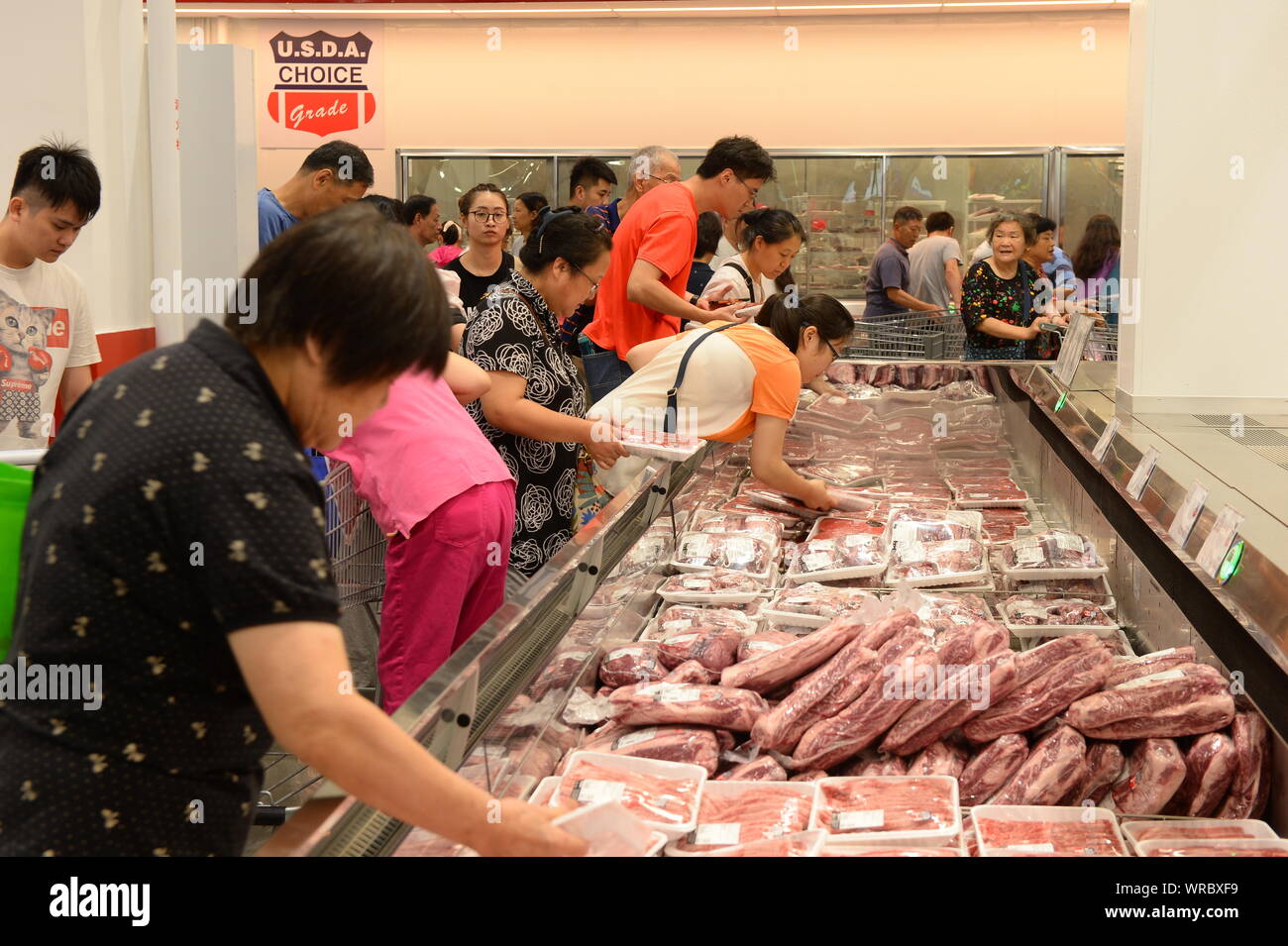 Chinese shoppers buy beef and other meat products at the Costco store in Shanghai, China on August 29th, 2019.   U.S. retailing chain giant Costco ann Stock Photo