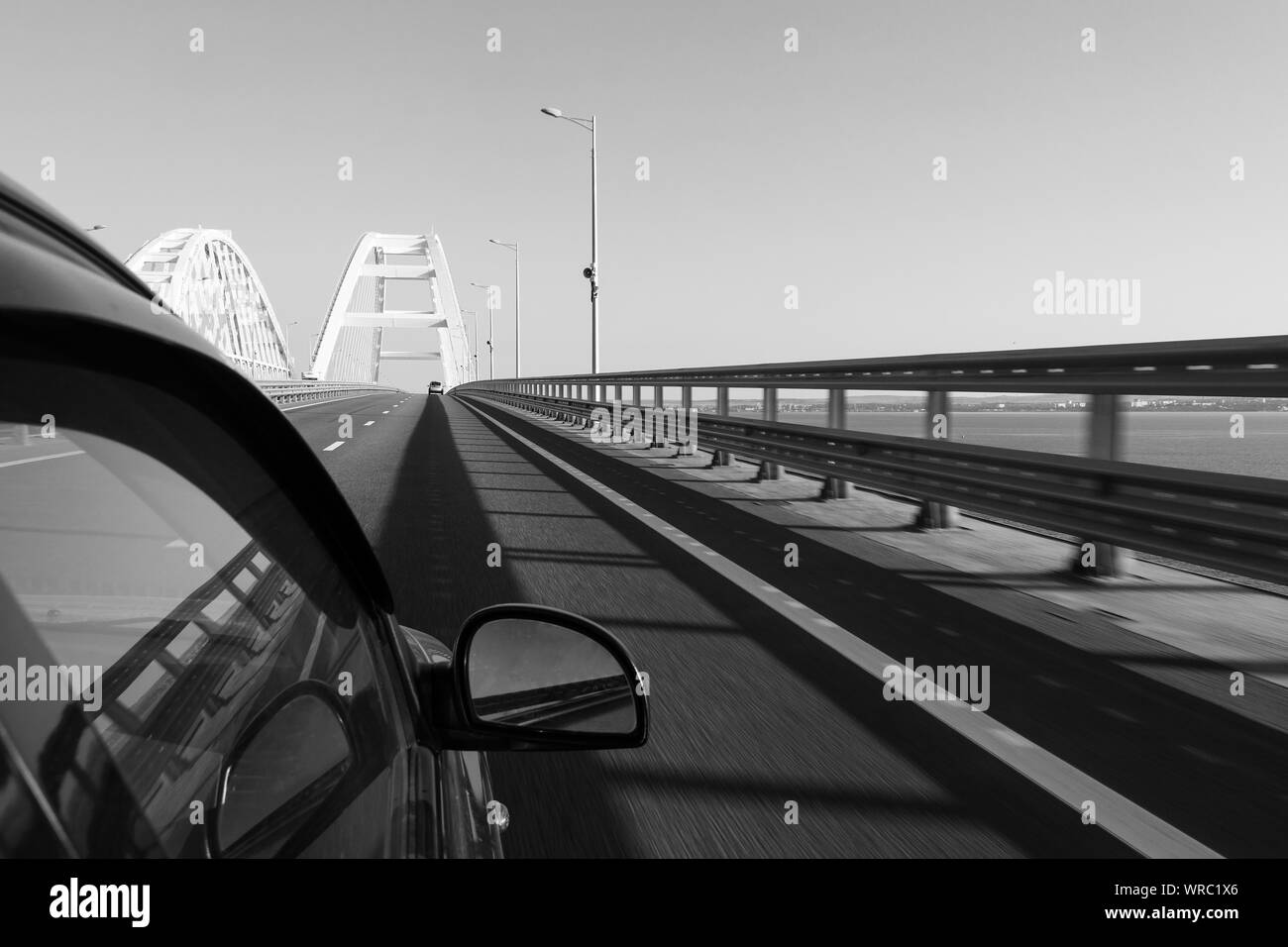Entry to the Crimean bridge by car, view of the Crimean bridge from the window of a moving car in the summer morning Stock Photo