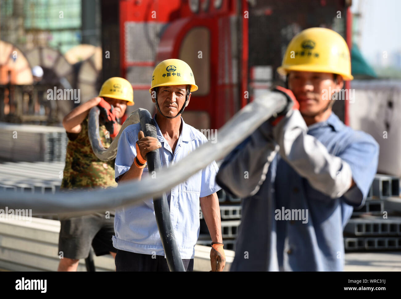 Chinese migrant workers of CREC (China Railway Group Limited) labor at the construction site of the Huai'an East Railway Station for high-speed railwa Stock Photo