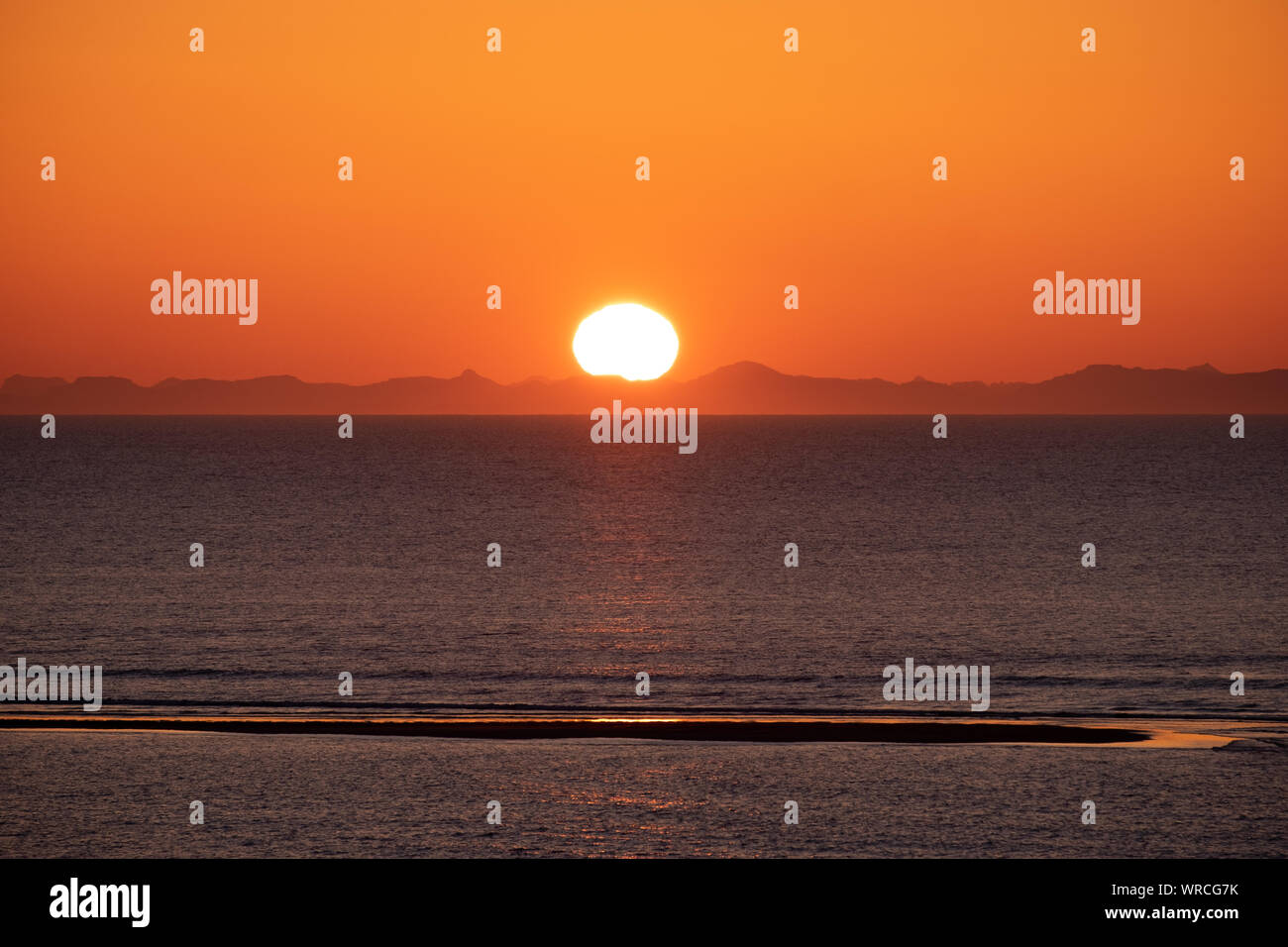 Sunset over sea and Canadian Mountains Stock Photo