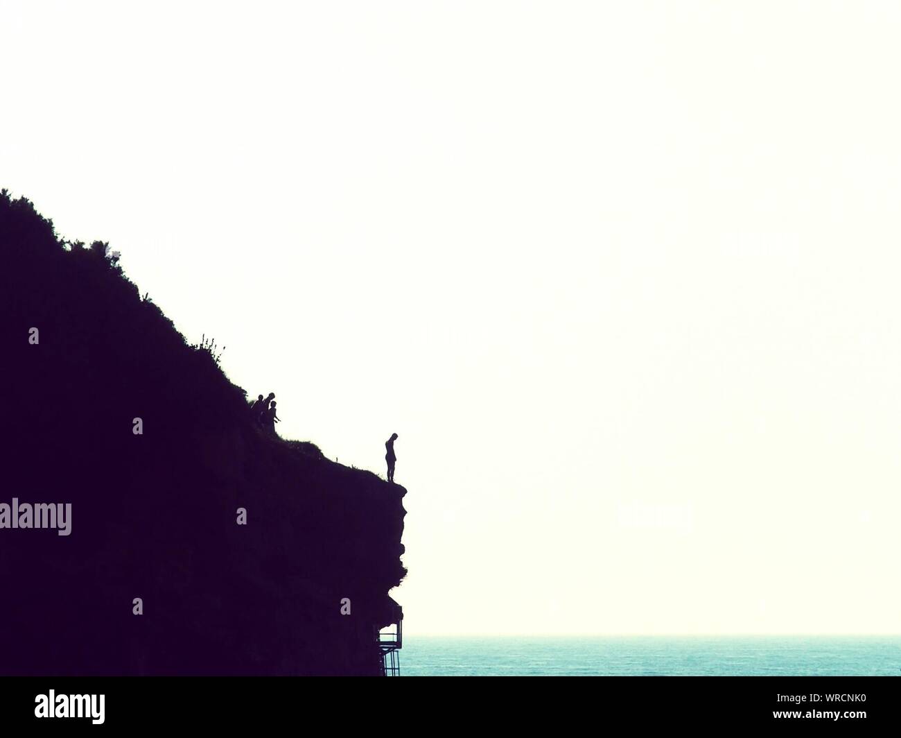 Person standing on cliff edge hi-res stock photography and images - Alamy
