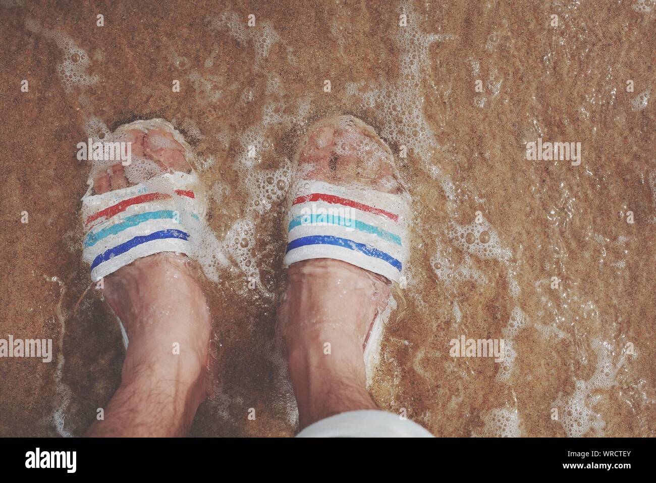 Man standing feet water hires stock photography and images Alamy
