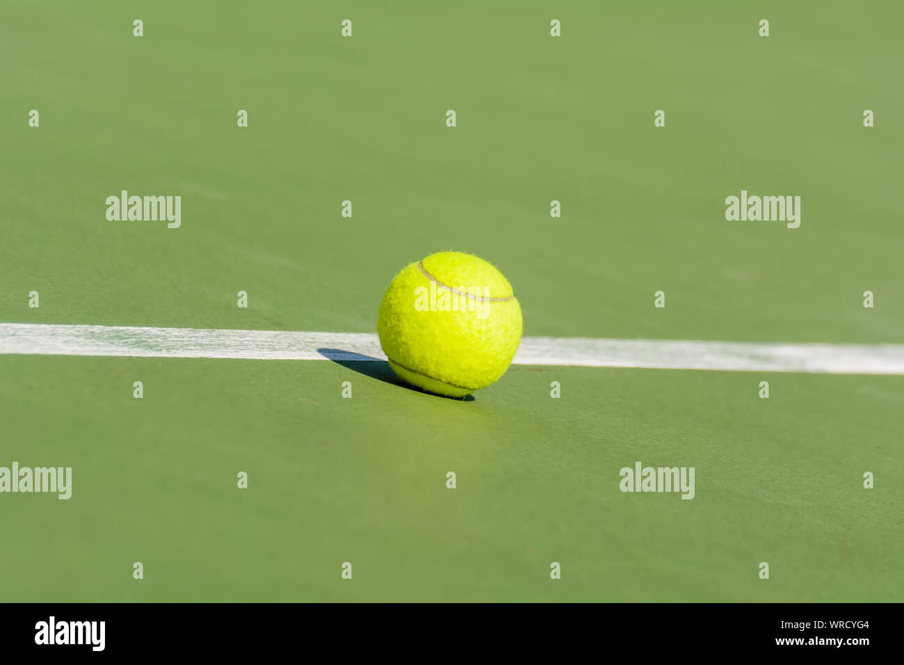 Green tennis balls are in a tennis court Stock Photo Alamy