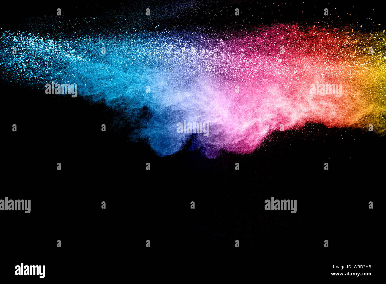 Colorful background of pastel powder explosion. Rainbow color dust splash on black background. Stock Photo