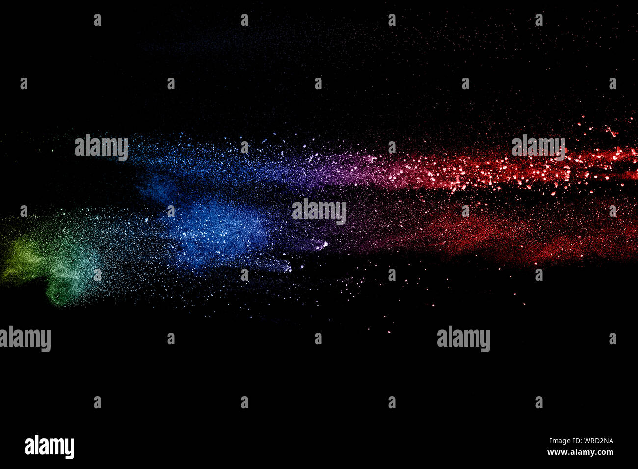 Colorful background of pastel powder explosion. Rainbow color dust splash on black background. Stock Photo