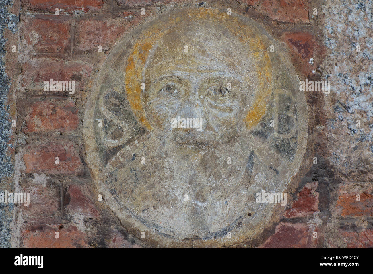 St.Benedict of Nursia in an old and vanishing tondo in the atrium of the Basilica of Sant'Ambrogio near the left entrance - Milan Stock Photo