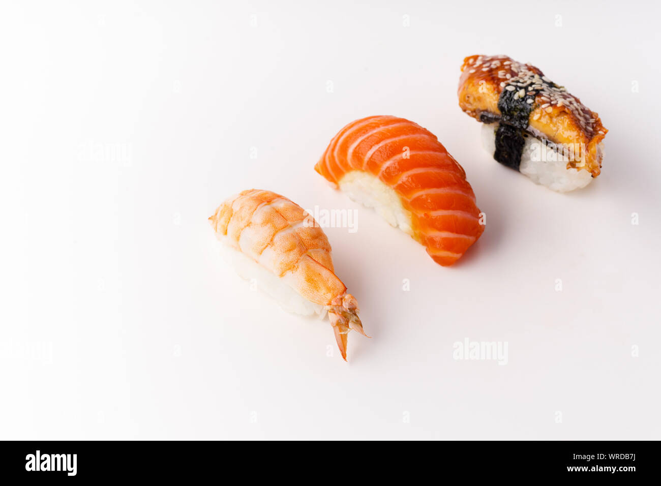 Creative layout with various sushi on white background. Shrimp, eel, salmon. Stock Photo