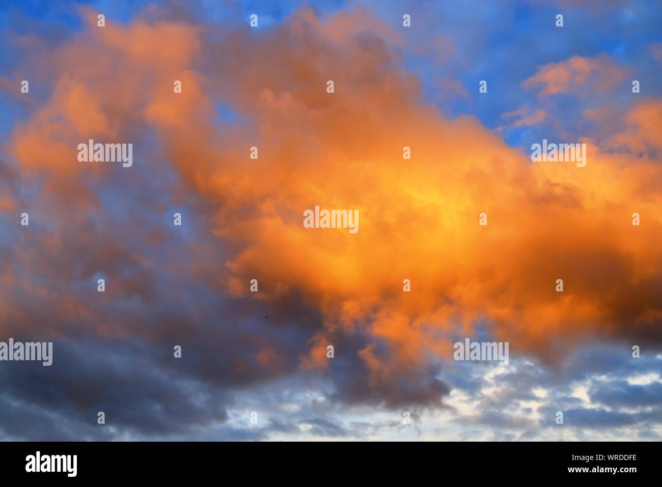 Beautiful panoramic view on orange and yellow sunset clouds in a ...