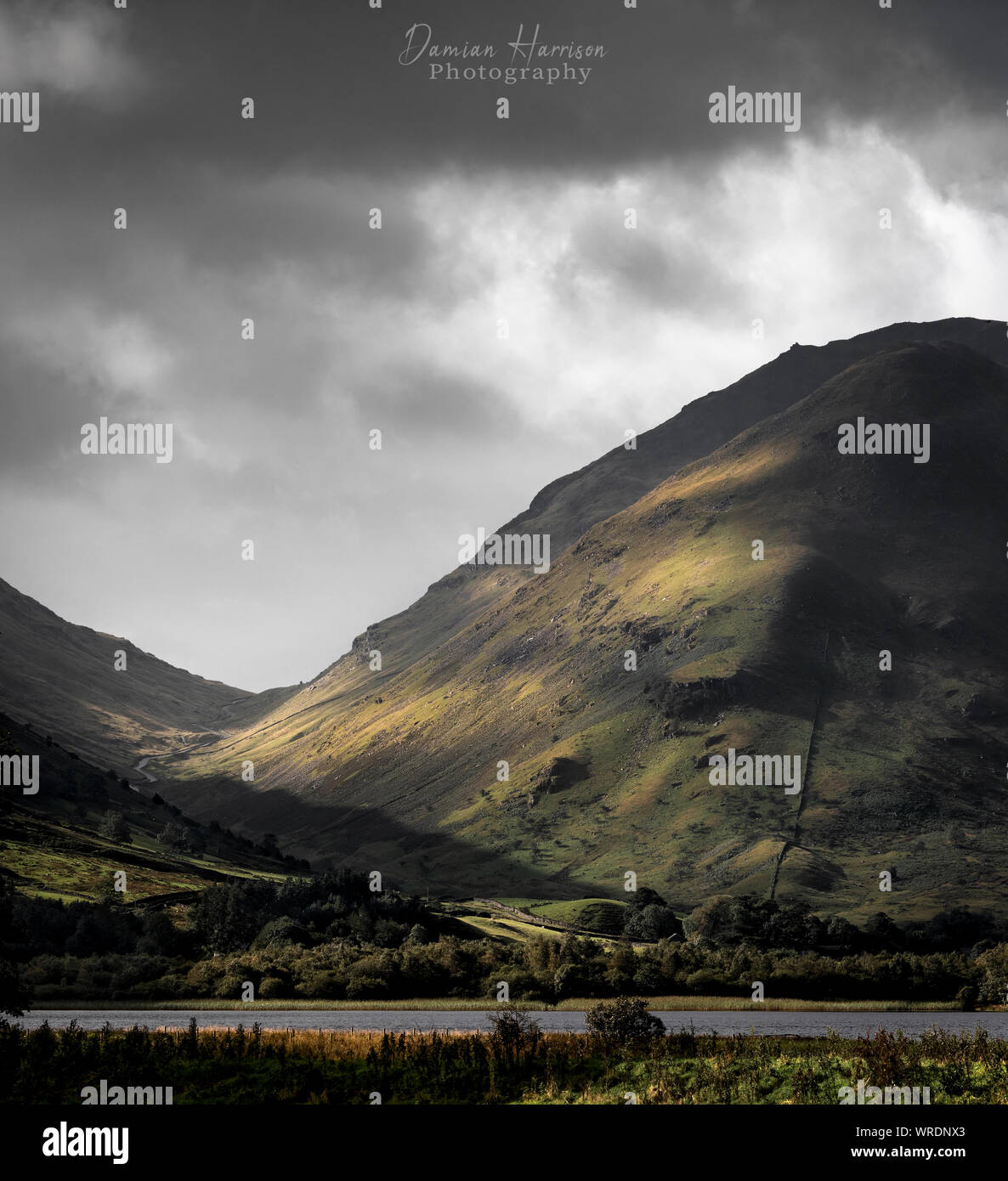 Stunning light and moody skies over Kirkstone Pass following a storm. Stock Photo