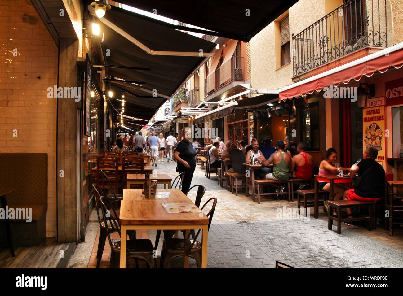 Benidorm, Alicante, Spain- September 7, 2019: Bar of typical spanish food full of people in the old town of Benidorm Stock Photo