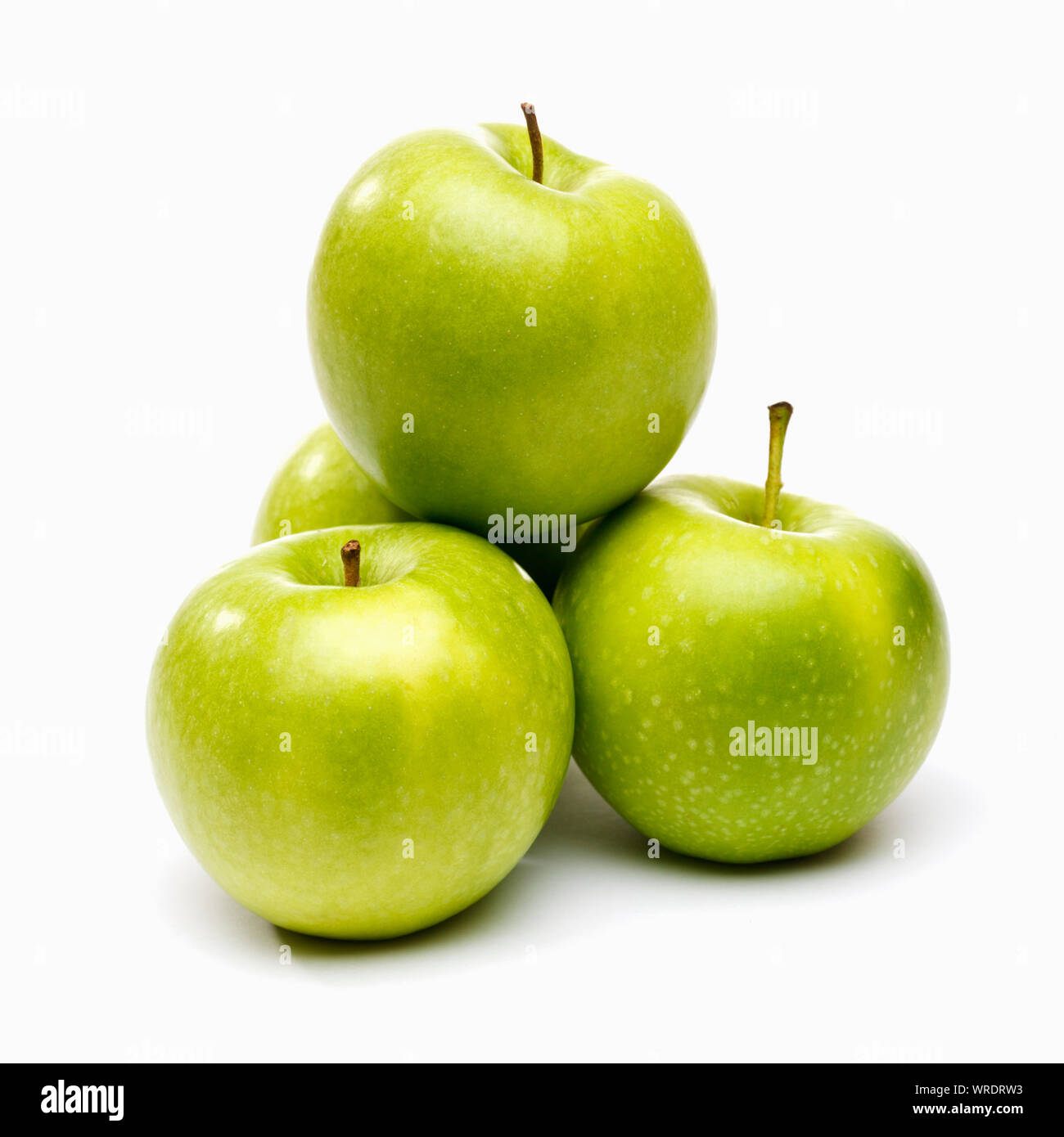 Apples, white background. Four green apples pile Stock Photo