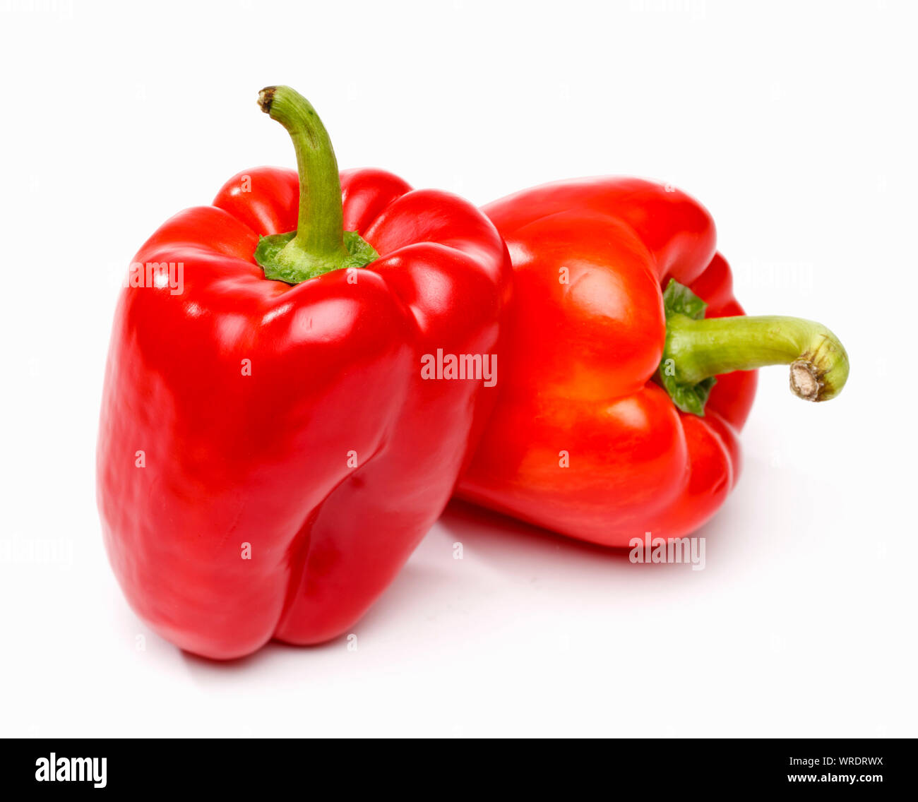 Two red bell peppers on a white background Stock Photo
