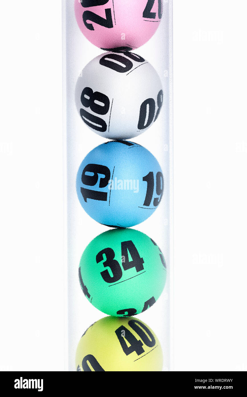 Five numbered multi coloured Lotto, Lottery or Bingo balls in a vertical clear plastic tube Stock Photo