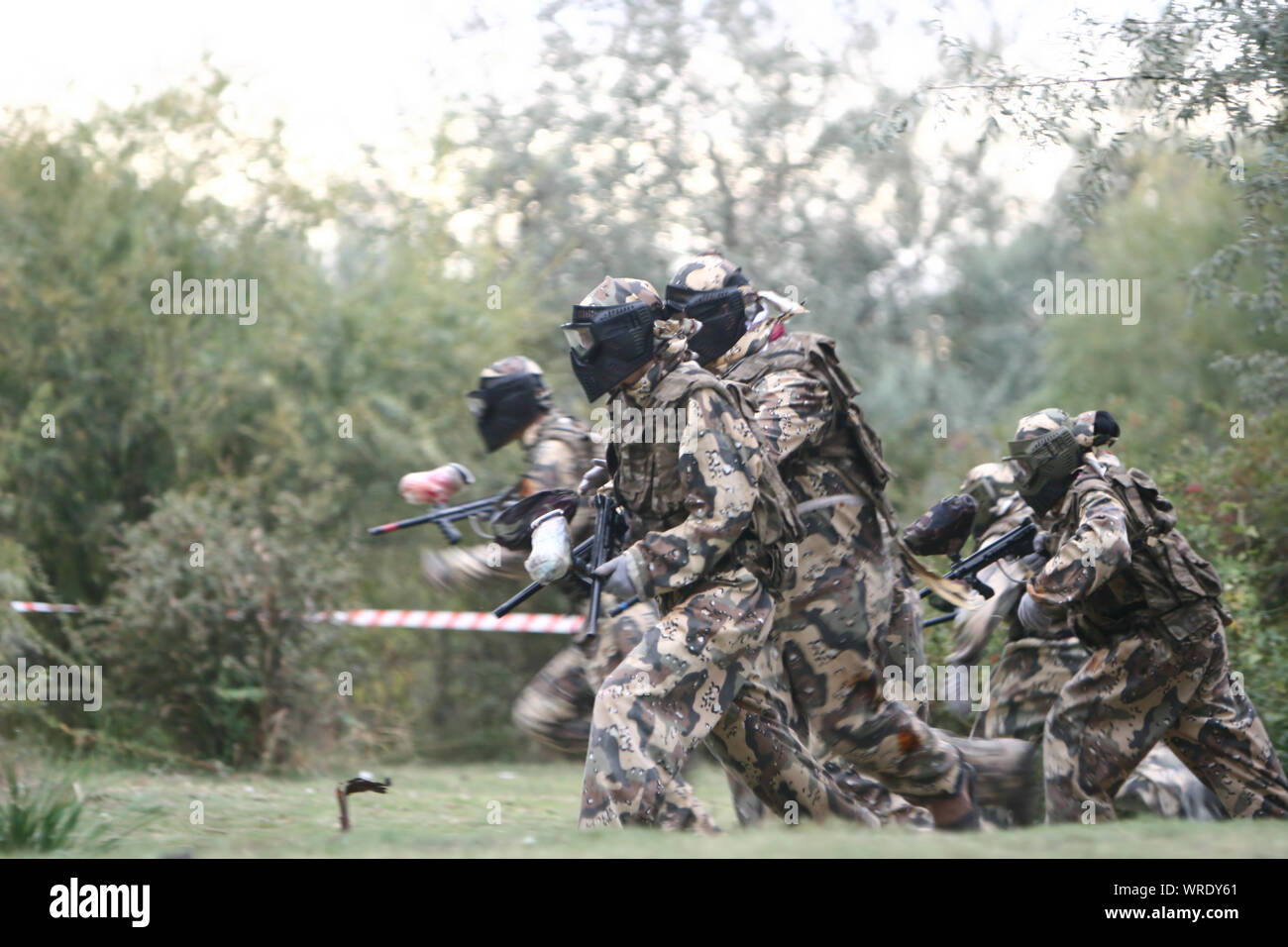 Team players in paintball attack enemy Stock Photo Alamy