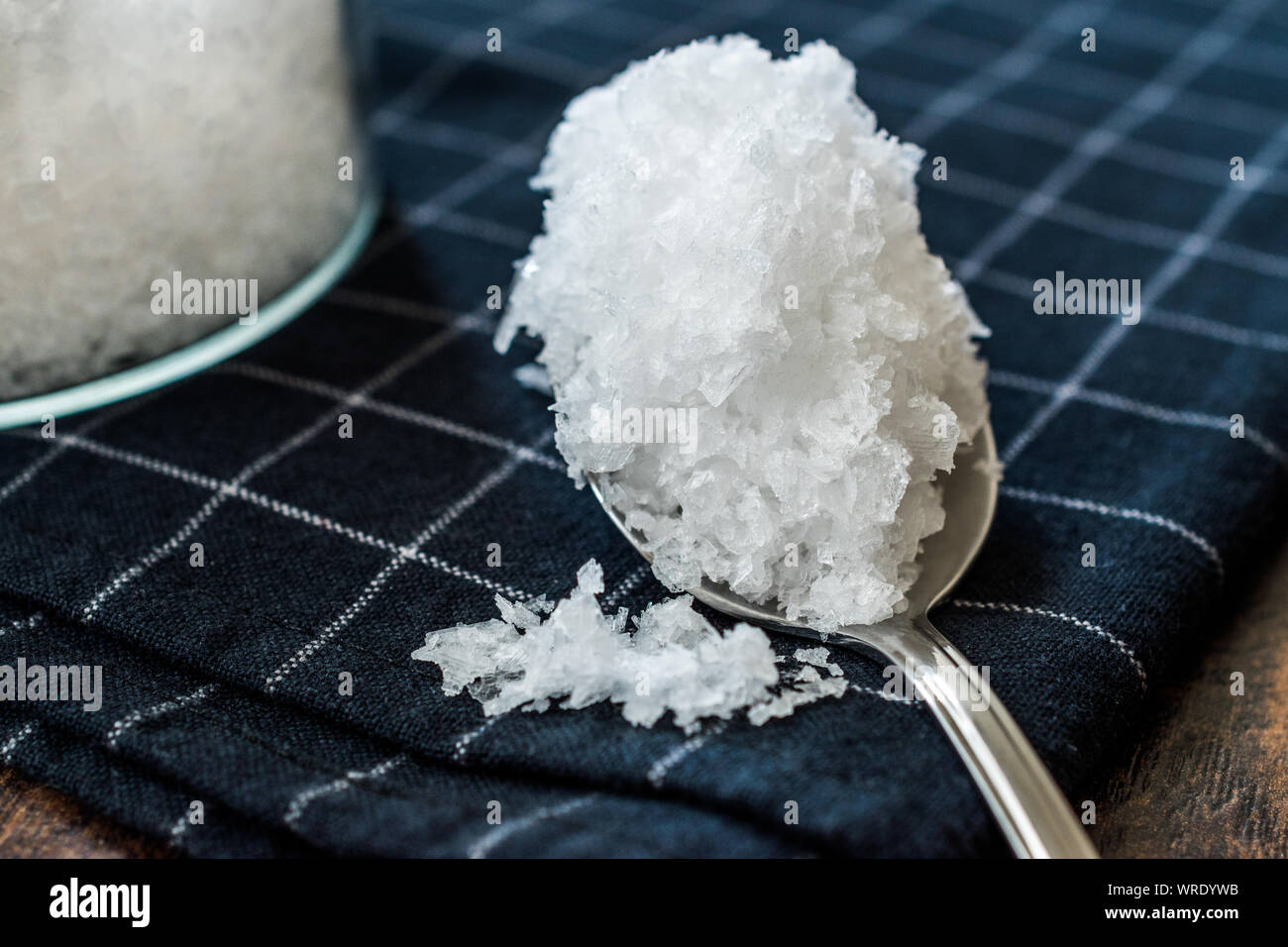 Maldon Sea Salt flakes in Jar with Spoon. Organic Food Product Stock