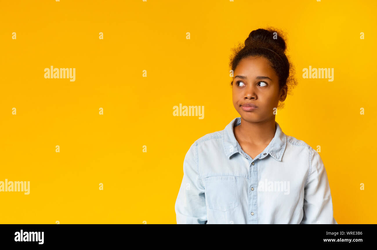 Annoyed african girl looking aside at free space Stock Photo