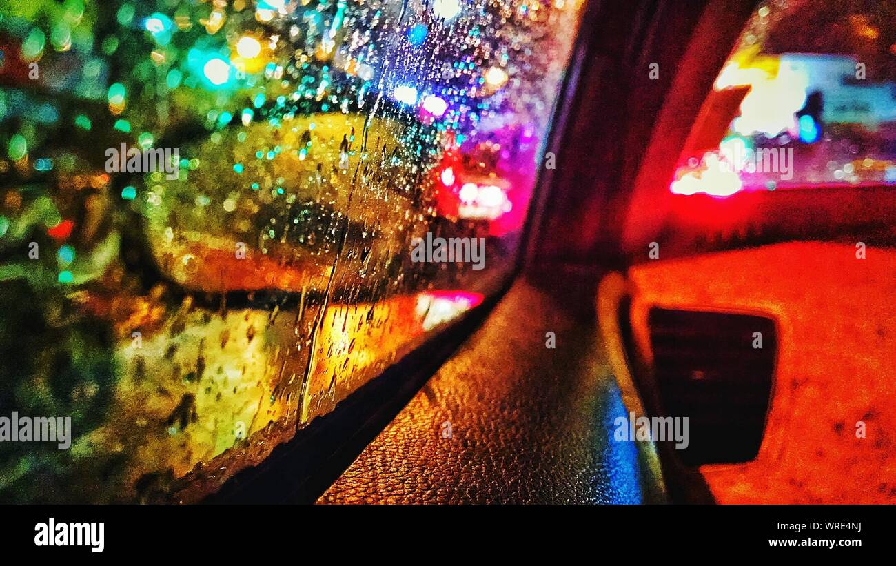 City Seen Through Car Window At Rainy Night Stock Photo