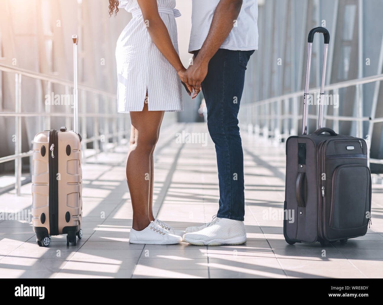 African couple in love holding hands before leaving at airport Stock ...