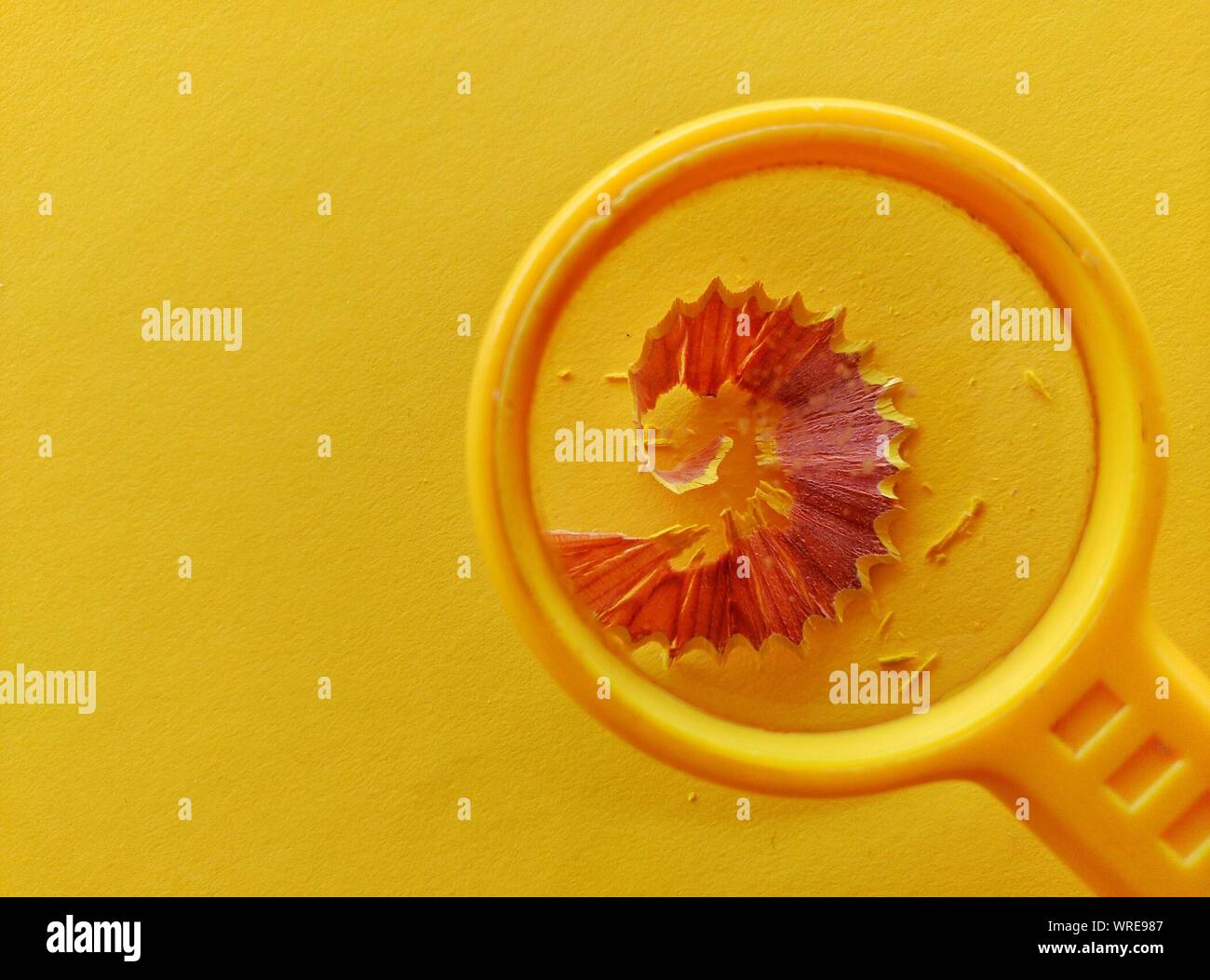 Pencil Shavings Being Magnified By Magnifying Glass Stock Photo