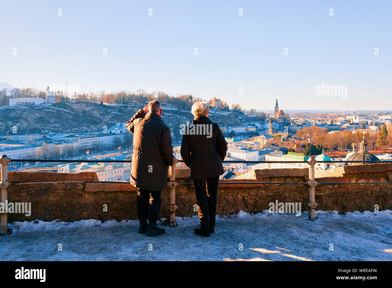 Senior couple looking at Panorama of Salzburg with snow Stock Photo