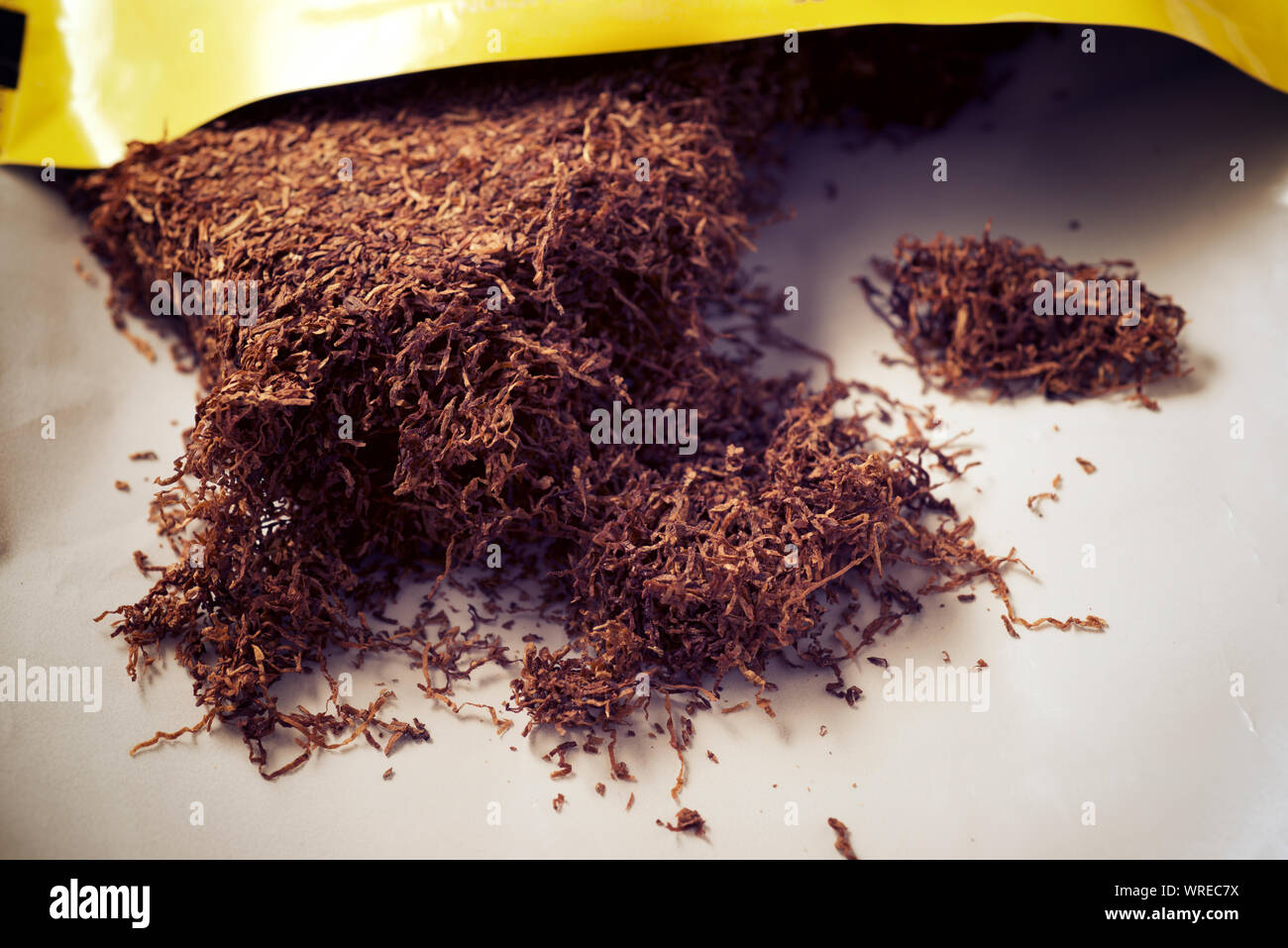 Hand rolling tobacco in a bag Stock Photo