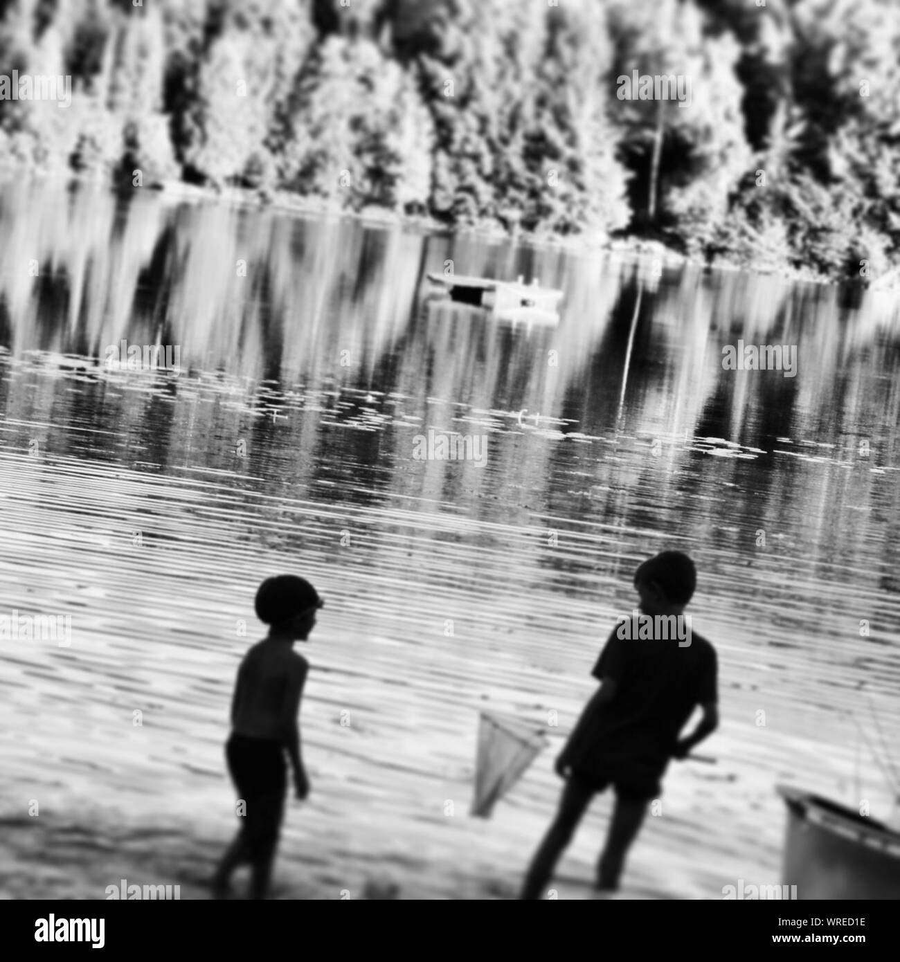 Two boys fishing Black and White Stock Photos & Images - Alamy