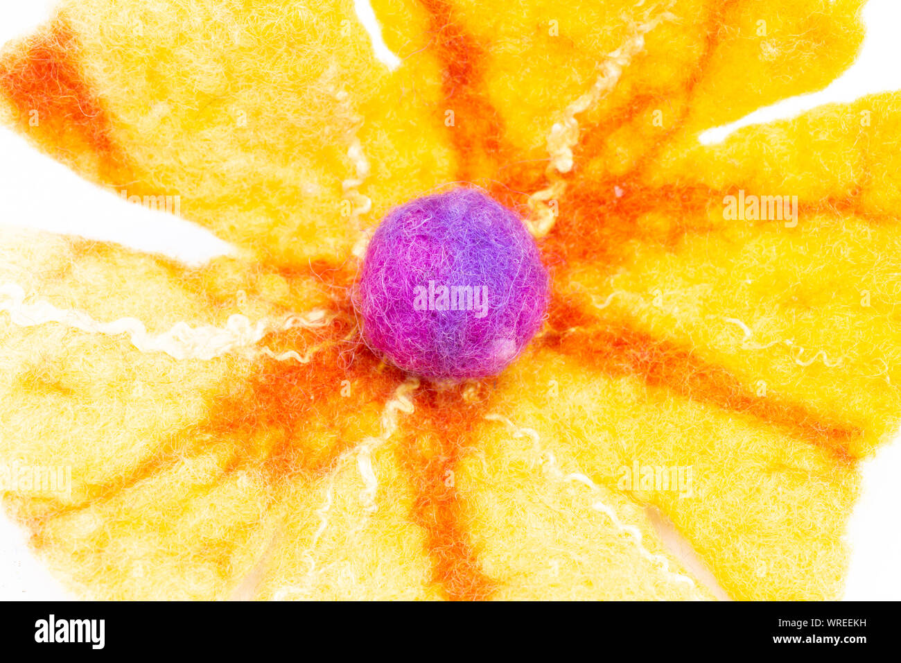 Colored wool macro - flower shape with small ball in the middle Stock Photo