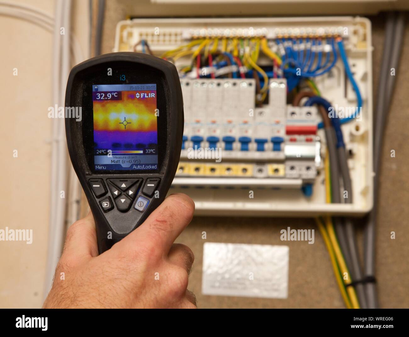 Using a thermal imaging device camera to test a mains electricity consumer unit, fuse box. Stock Photo