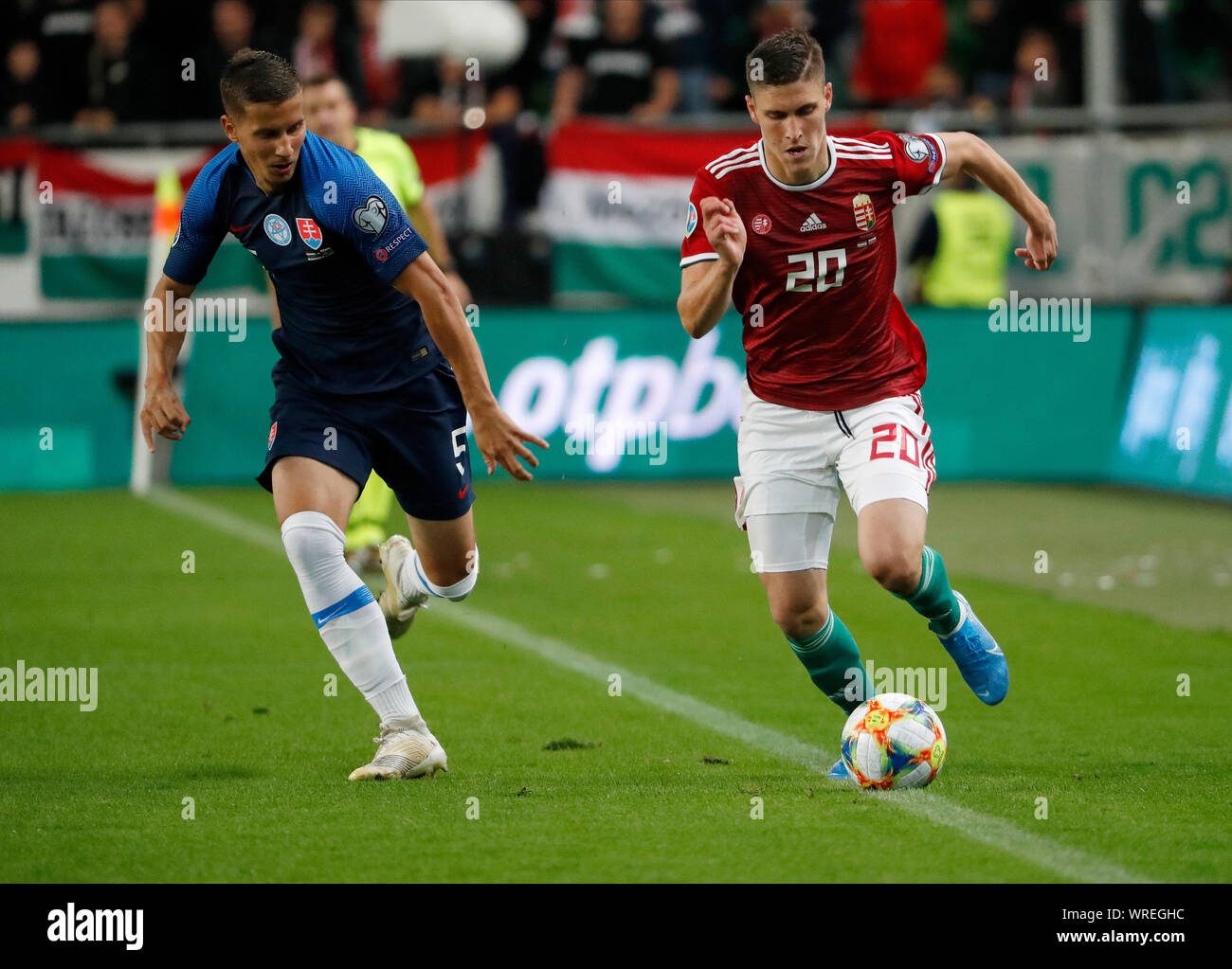 BUDAPEST, HUNGARY - SEPTEMBER 9: (r-l) Roland Sallai of Hungary controls the ball beside Lubomir Satka of Slovakia during the 2020 UEFA European Championships group E qualifying match between Hungary and Slovakia at Groupama Arena on September 9, 2019 in Budapest, Hungary. Stock Photo