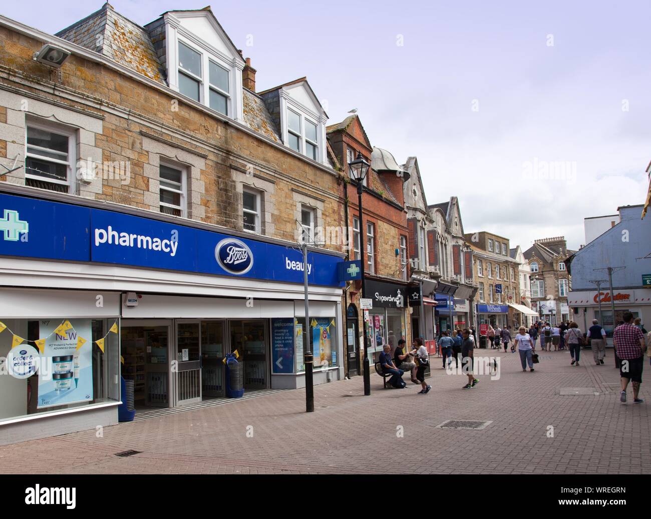 View into Bank Street, Newquay town centre, Cornwall UK.Boots the chemist. Stock Photo