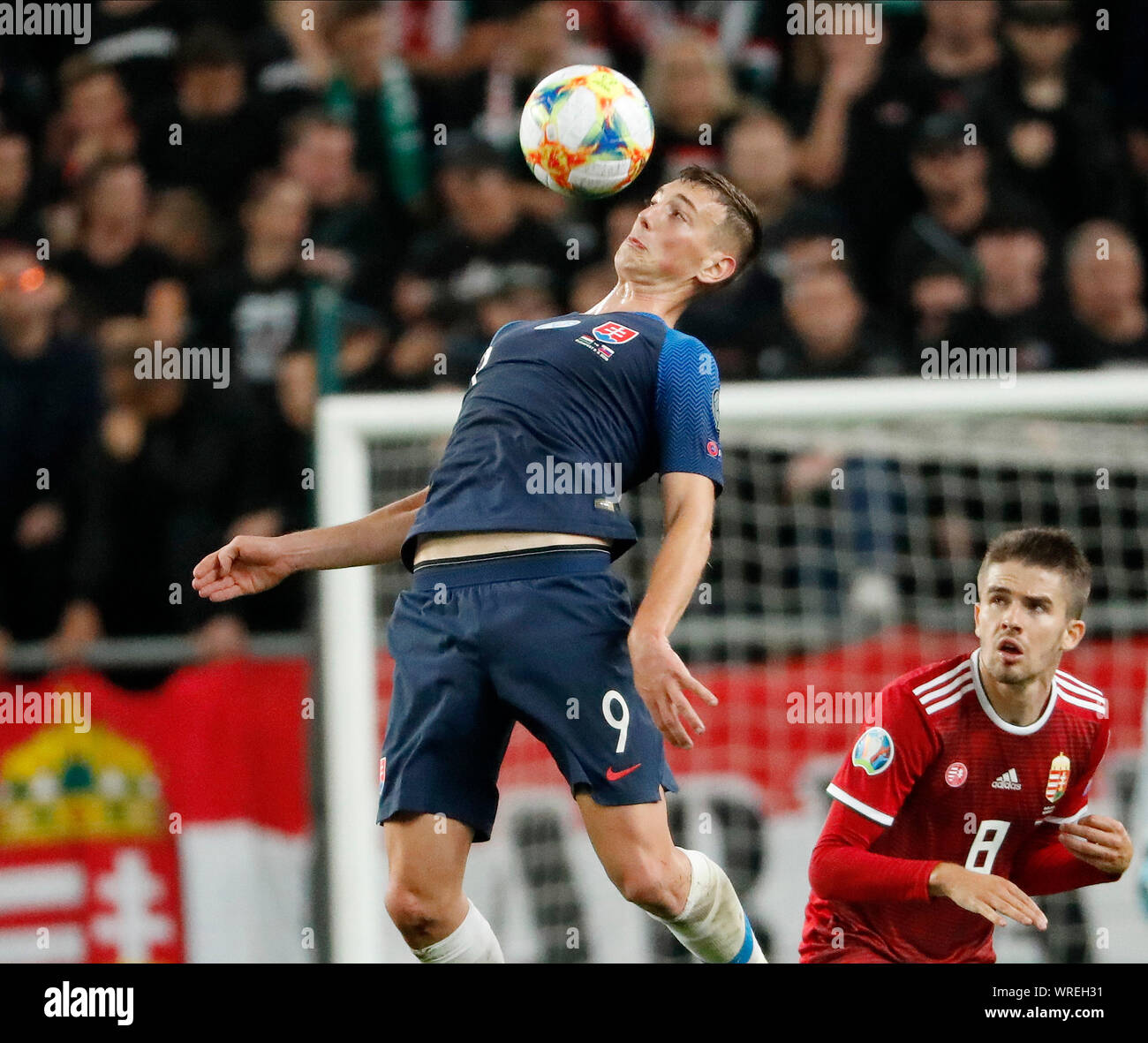 BUDAPEST, HUNGARY - SEPTEMBER 9: (l-r) Robert Bozenik of Slovakia controls the ball next to Adam Nagy of Hungary during the 2020 UEFA European Championships group E qualifying match between Hungary and Slovakia at Groupama Arena on September 9, 2019 in Budapest, Hungary. Stock Photo