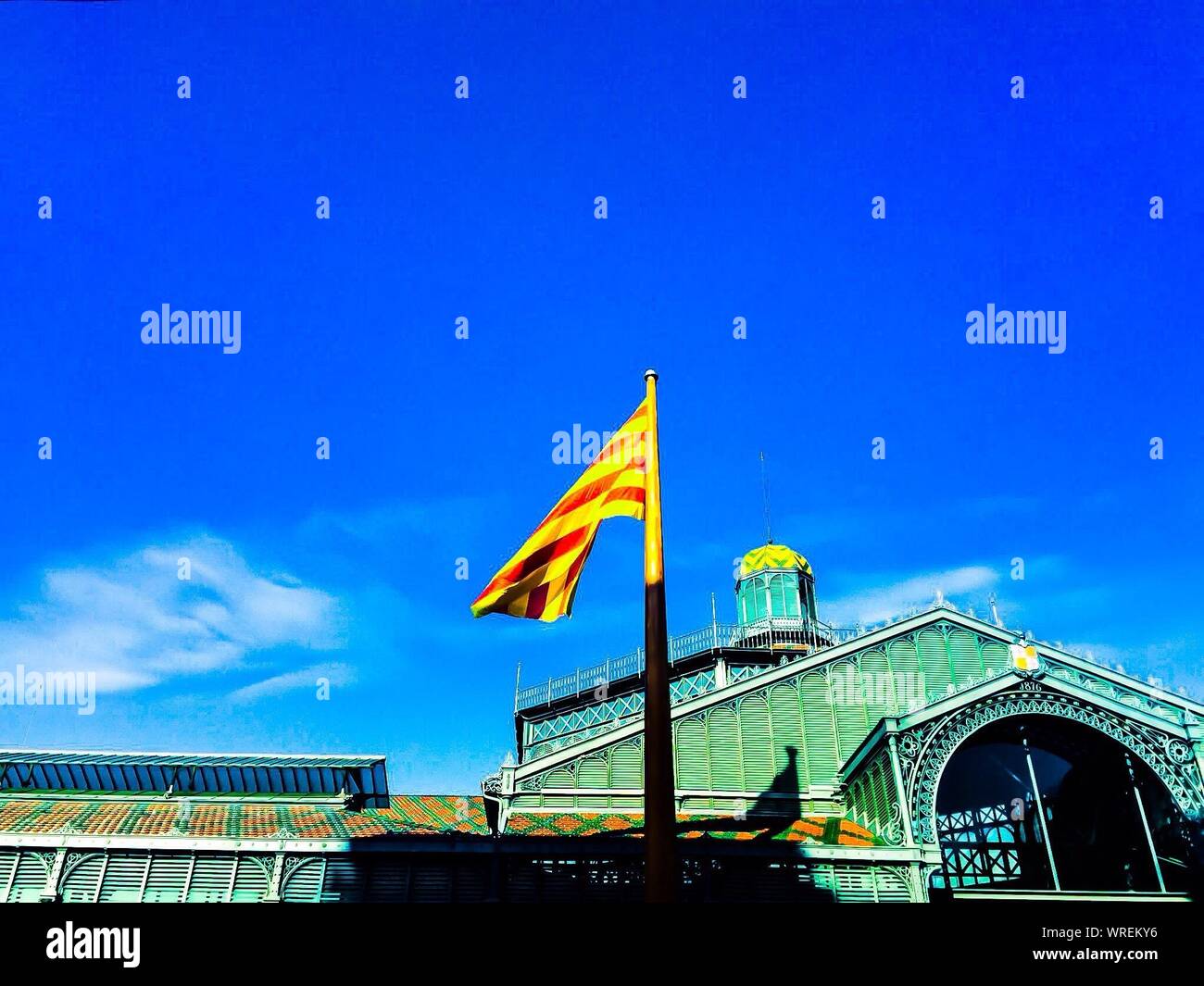 Low Angle View Of Catalonian Flag Against Blue Sky Stock Photo