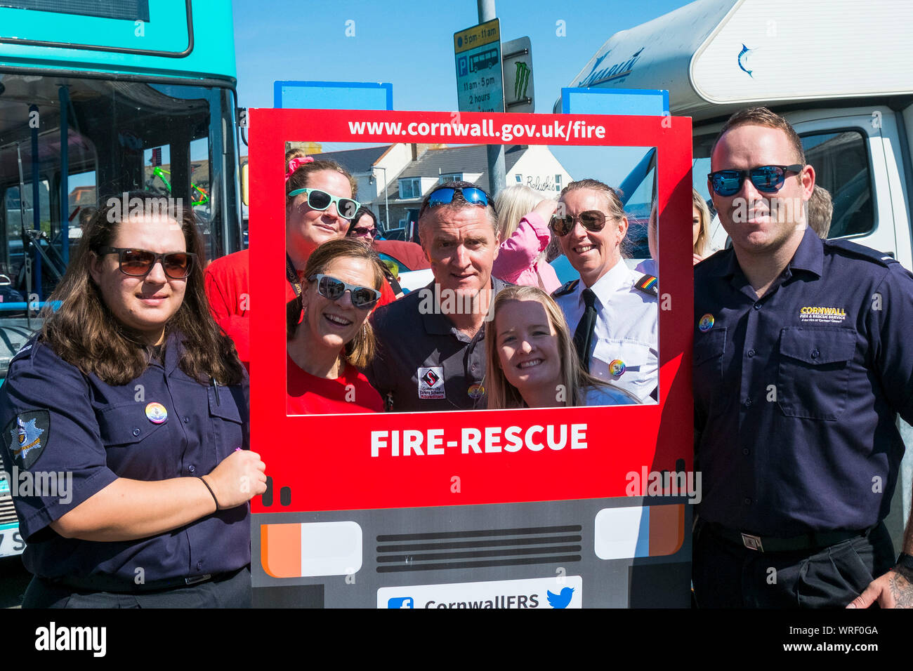 People posing with members of the Cornwall Fire and Rescue Service. Stock Photo