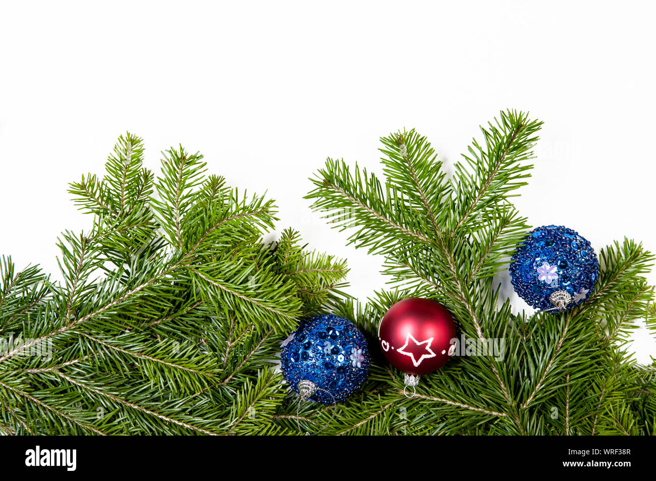 Christmas background. Christmas fir tree with decoration on white background. Top view, copy space Stock Photo