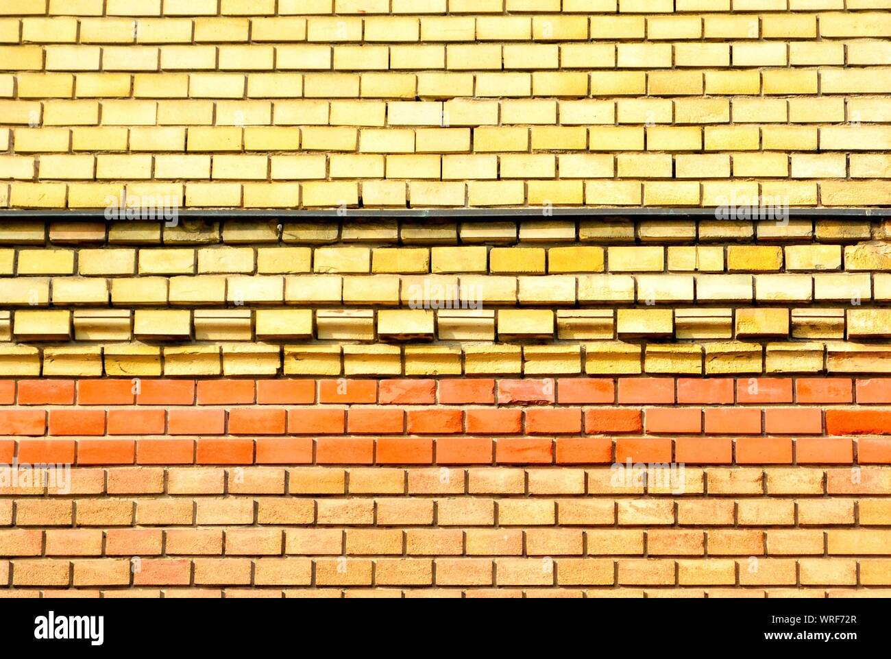 Full Frame Shot Of Yellow Brick Wall Stock Photo