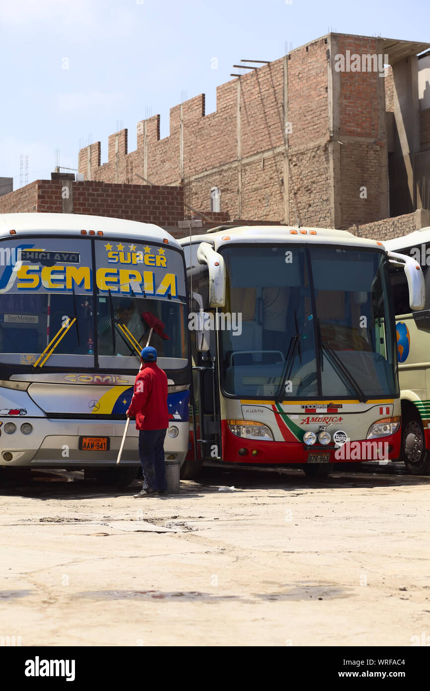 CHICLAYO, PERU - AUGUST 16, 2013: Unidentified person cleaning the window of a long-distance bus at bus terminal on August 16, 2013 in Chiclayo, Peru Stock Photo