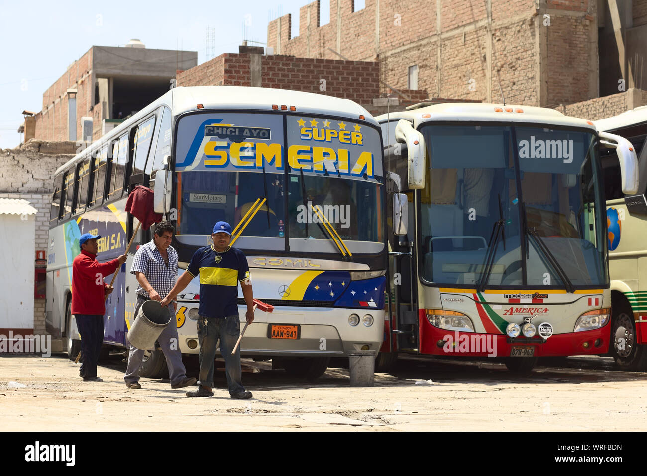 CHICLAYO, PERU - AUGUST 16, 2013: Unidentified people cleaning  a long-distance bus at a bus terminal on August 16, 2013 in Chiclayo, Peru. Stock Photo