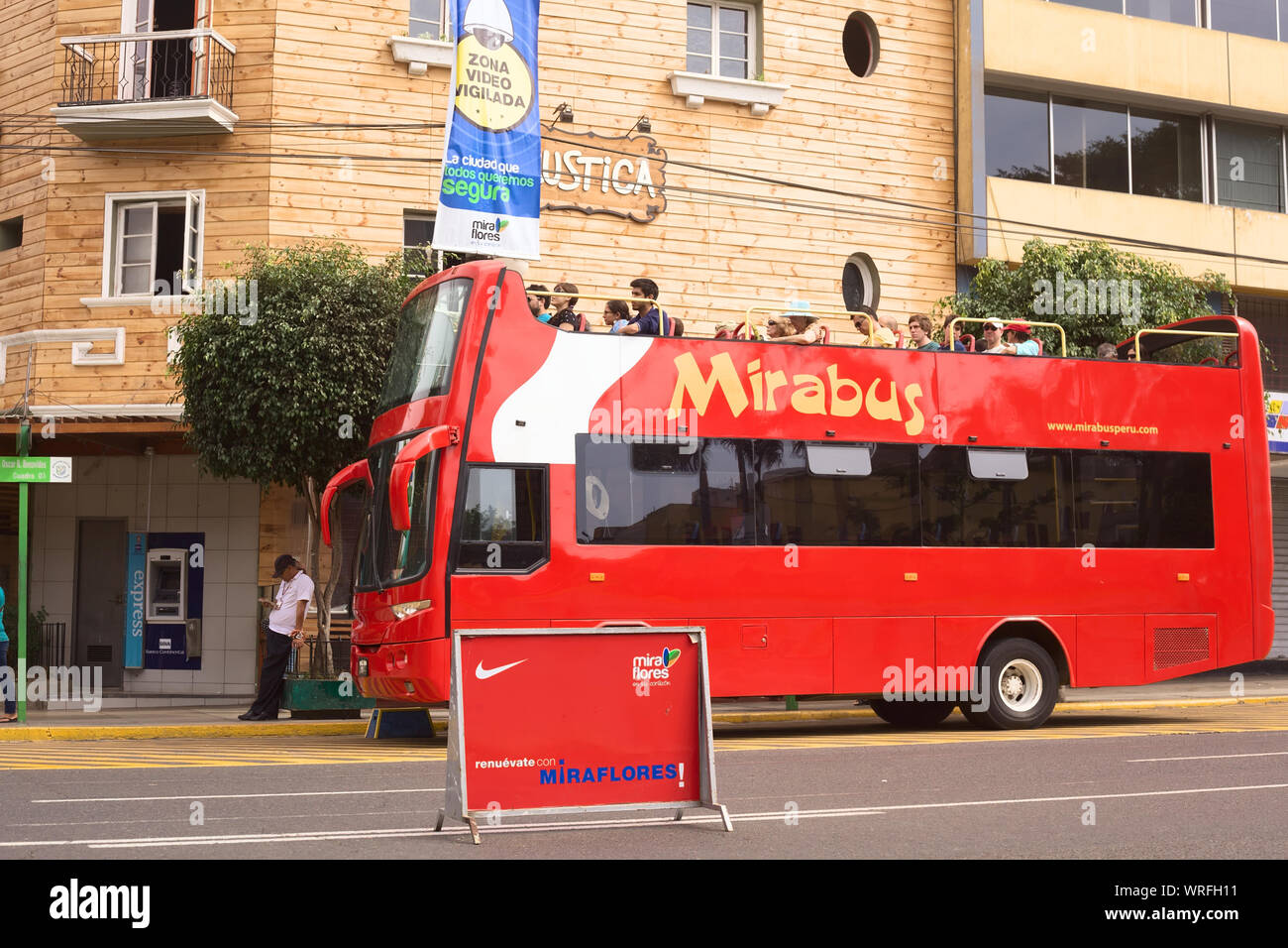 LIMA, PERU - APRIL 1, 2012: Unidentified people on Mirabus sightseeing bus in front of the restaurant Rustica on Av. Diagonal in Miraflores Stock Photo
