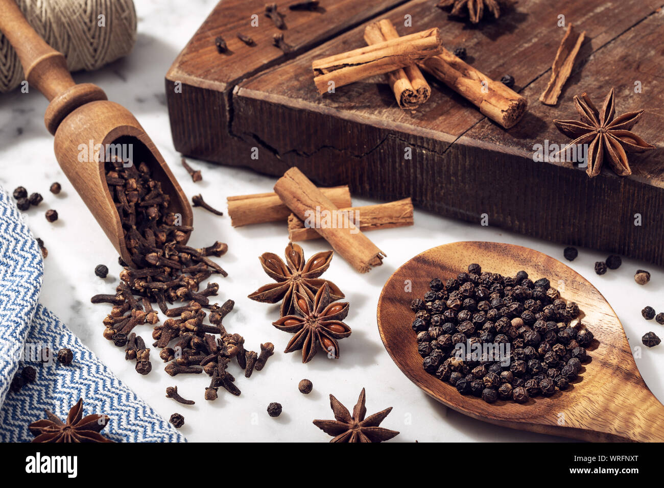Set of spices on marble table. Star anise, cinnamon, clove and black pepper for cuisine Stock Photo